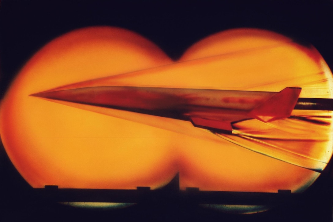 A jet streaks through a wind tunnel.