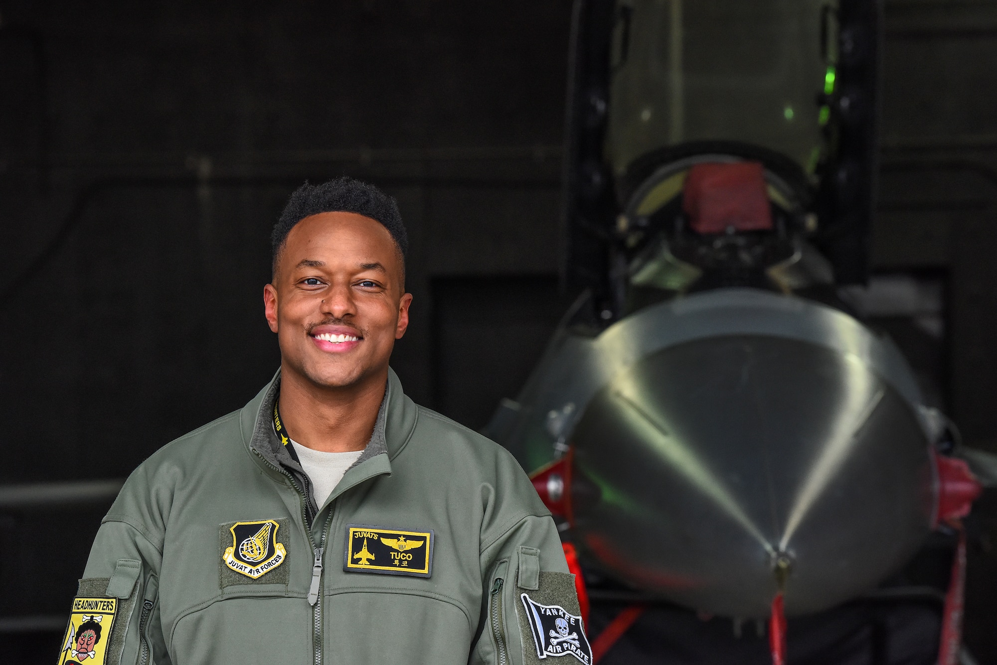 Maj. Chris "Tuco" Harrison, 80th Fighter Squadron assitant director of operations and chief of standards and evaluations, poses for a photo in front of an F-16 Fighting Falcon on the flightline at Kunsan Air Base, Republic of Korea, Feb. 18, 2021. Harrison commissioned out of Tuskegee University ROTC detachment back in 2011 and follwoed his dream to become a pilot in the U.S. Air Force. (U.S. Air Force photo by Senior Airman Suzie Plotnikov)