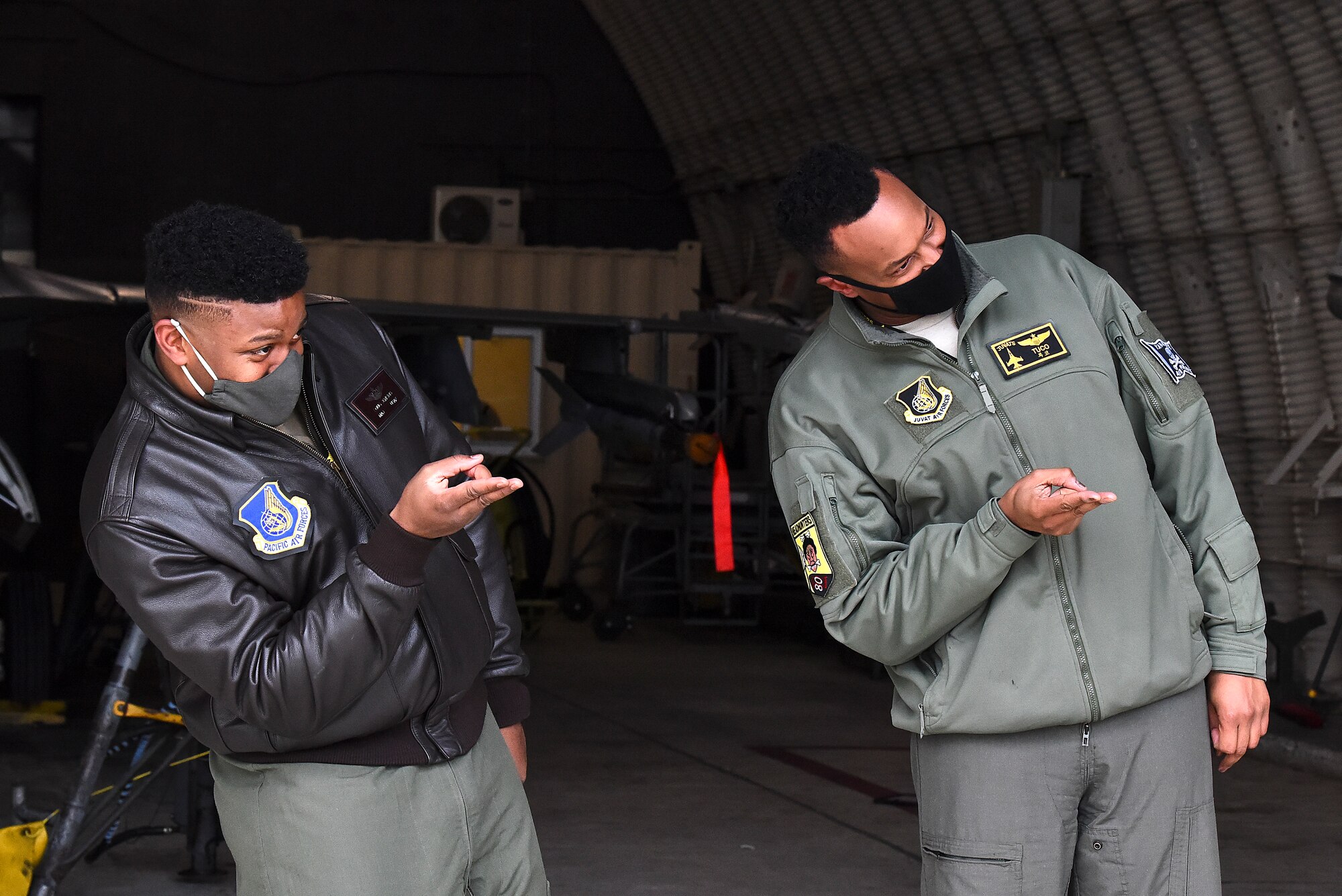 Maj. Douglas "Bane" Jenkins, 8th Fighter Wing Advanced Programs Office program manager, and Maj. Chris "Tuco" Harrison, 8th Fighter Squadron assistant director of operations and chief of standards and evaluations, pose for a photo in front of an F-16 Fighting Falcon on the flightline at Kunsan Air Base, Republic of Korea, Feb. 17, 2021. Harrison and Jenkins attended Tuskegee University together and are now both assigned to the same unit at the Wolf Pack. (U.S. Air Force photo by Senior Airman Suzie Plotnikov)