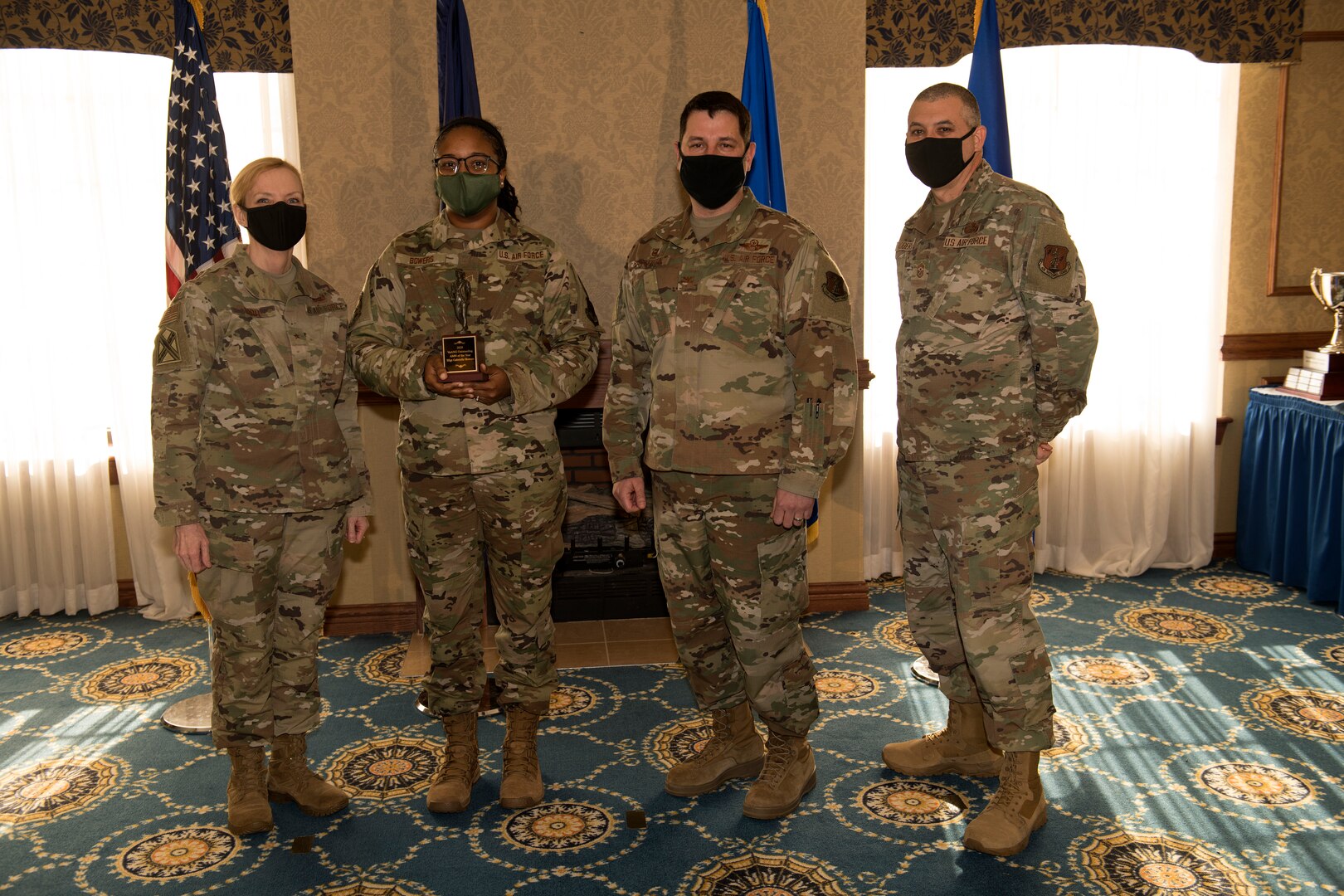 Airman stop to receive their awards during a ceremony