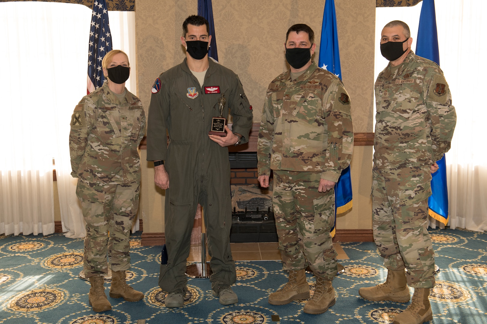 An Airman accepts an award during a ceremony