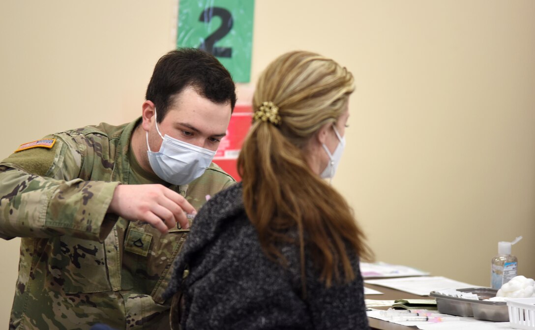 A Soldier with the Michigan Army National Guard administers a COVID-19 vaccine to a resident in Benton Harbor, Michigan, Feb. 19, 2021. The Guard has been helping state health officials vaccinate people across the state.