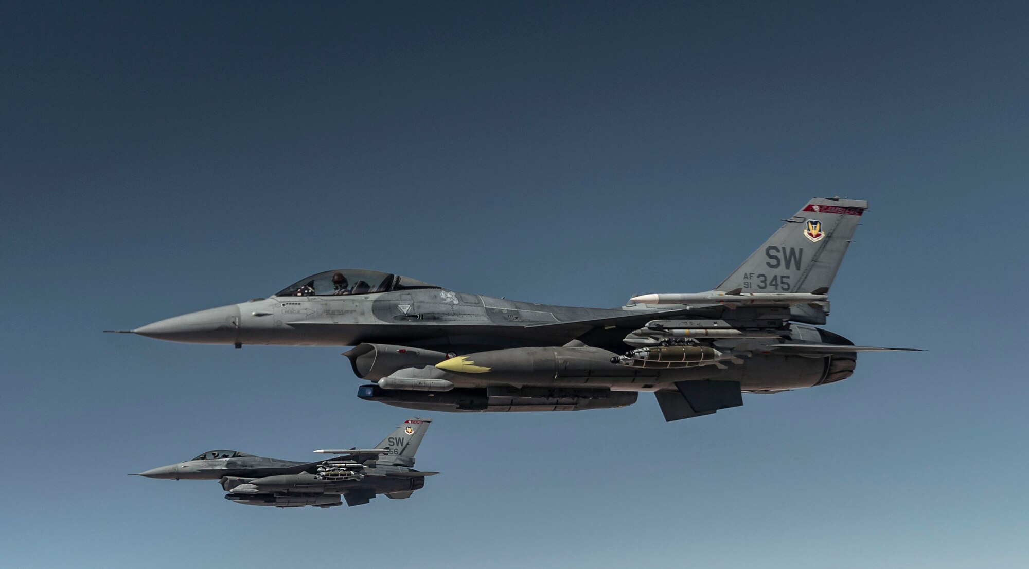 Two U.S. Air Force F-16 Fighting Falcon pilots fly alongside  a KC-135 Stratotanker, assigned to the 340th Expeditionary Aircraft Refueling Squadron, after receiving fuel while flying routine operations over Southwest Asia Feb. 16th, 2021.