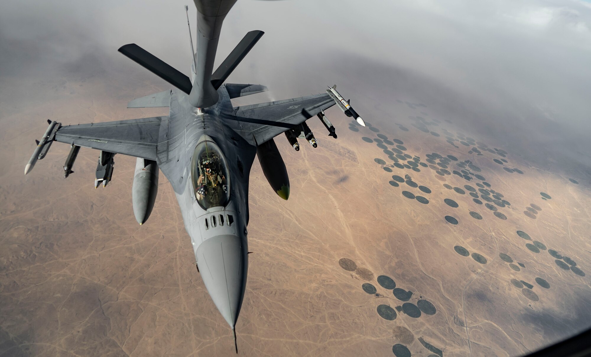 A U.S. Air Force F-16 Fighting Falcon receives fuel from a KC-135 Stratotanker, assigned to the 340th Expeditionary Aircraft Refueling Squadron, while flying routine operations over Southwest Asia Feb. 16th, 2021.