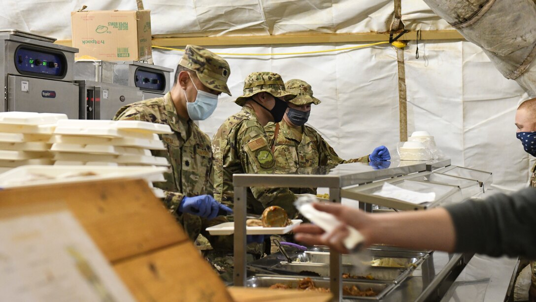 Leadership from the 768th Expeditionary Air Base Squadron get behind the counter to serve food to military members deployed to Nigerien Air Base 101, Niamey, Niger, Feb. 13, 2021. The 768 EABS leadership served lunch to deployed members to boost morale. (U.S. Air Force photo by Senior Airman Gabrielle Winn)