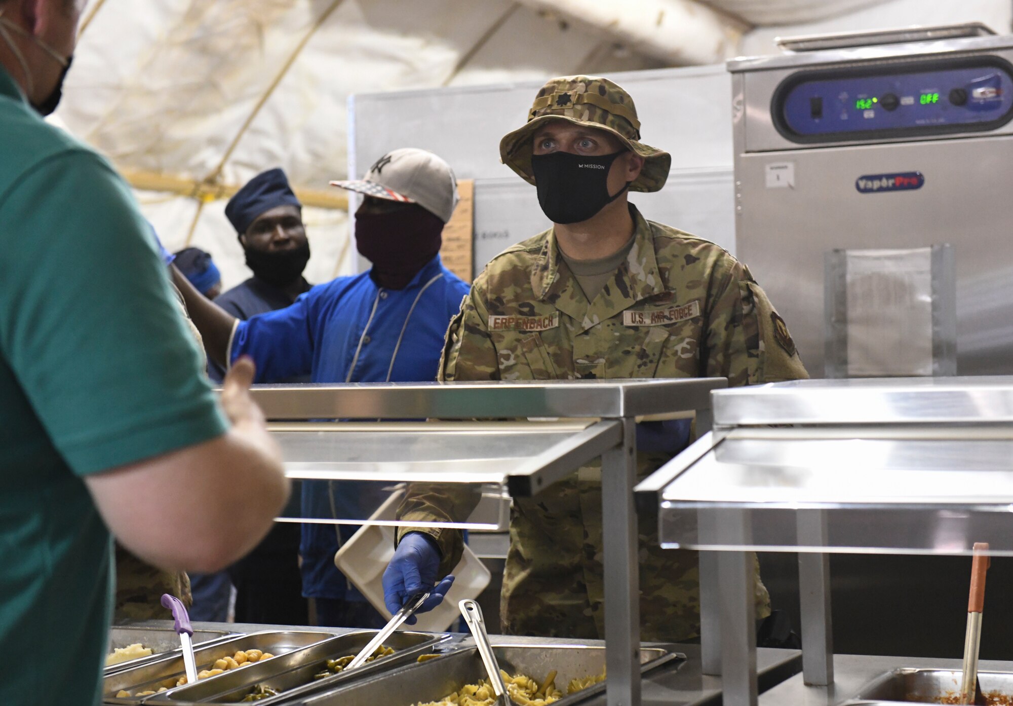 U.S. Air Force Lt. Col. Matthew Erpenbach, 768th Expeditionary Air Base Squadron deputy commander, prepares a plate of food for a military member at Nigerien Air Base 101, Niamey, Niger, Feb. 13, 2021. The command leadership served lunch to deployed members to boost morale. (U.S. Air Force photo by Senior Airman Gabrielle Winn)