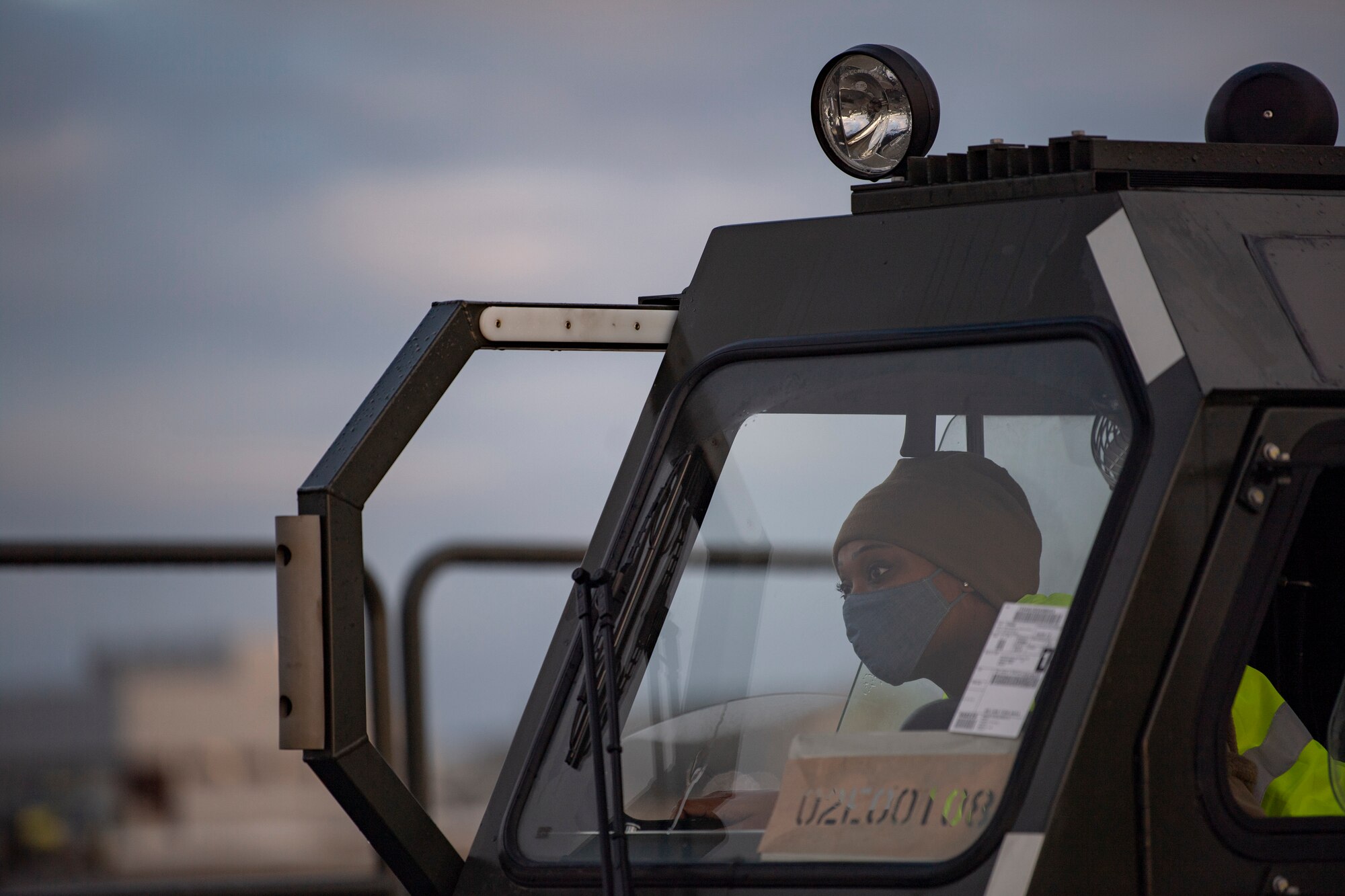 A ground transportation operator, assigned to the 9th Expeditionary Bomb Squadron operates a Halverson 25K Loader cargo transportation vehicle at Orland Air Force Station, Norway, Feb. 23, 2021. The Halverson 25K Loader is used to load and unload large and heavy cargo from an aircraft. (U.S. Air Force photo by Airman 1st Class Colin Hollowell)