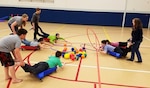 KODIAK, Alaska - The Base Kodiak Teen Center battle in a game of life-size Hungry Hippo. Coast Guard Base Kodiak, Alaska, is one of the largest Coast Guard bases in the world with more than 3,500 active duty, retired military, civilians, and their family members in the area. Kodiak, also known as the "Emerald Island," is located approximately 250 miles southwest of Anchorage and is home to the base’s Morale, Well-Being and Recreation (MWR) program. The program hosts several youth activities such as youth sports. (U.S. Coast Guard photo.)