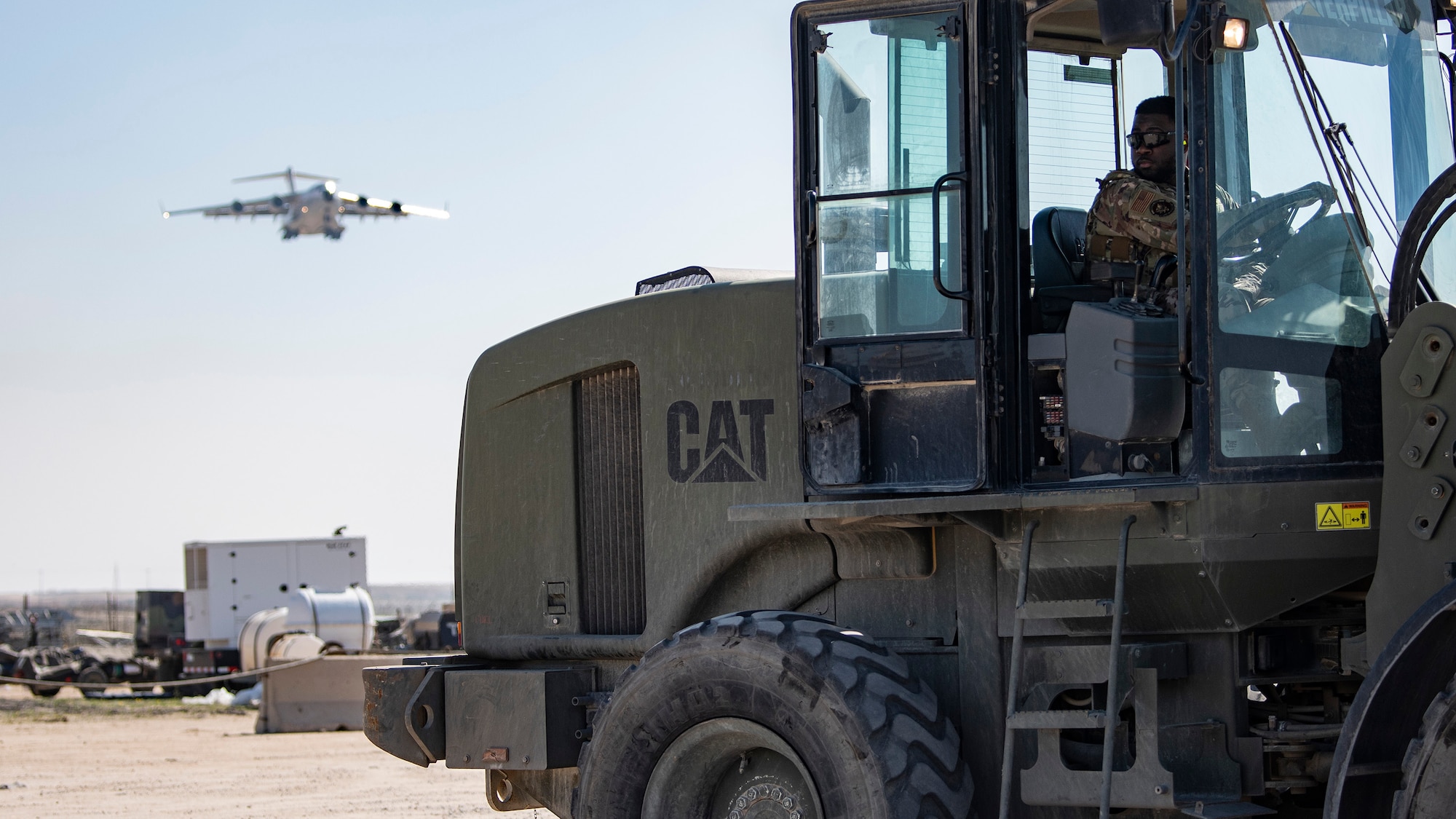 A photo of an Airman driving machinery
