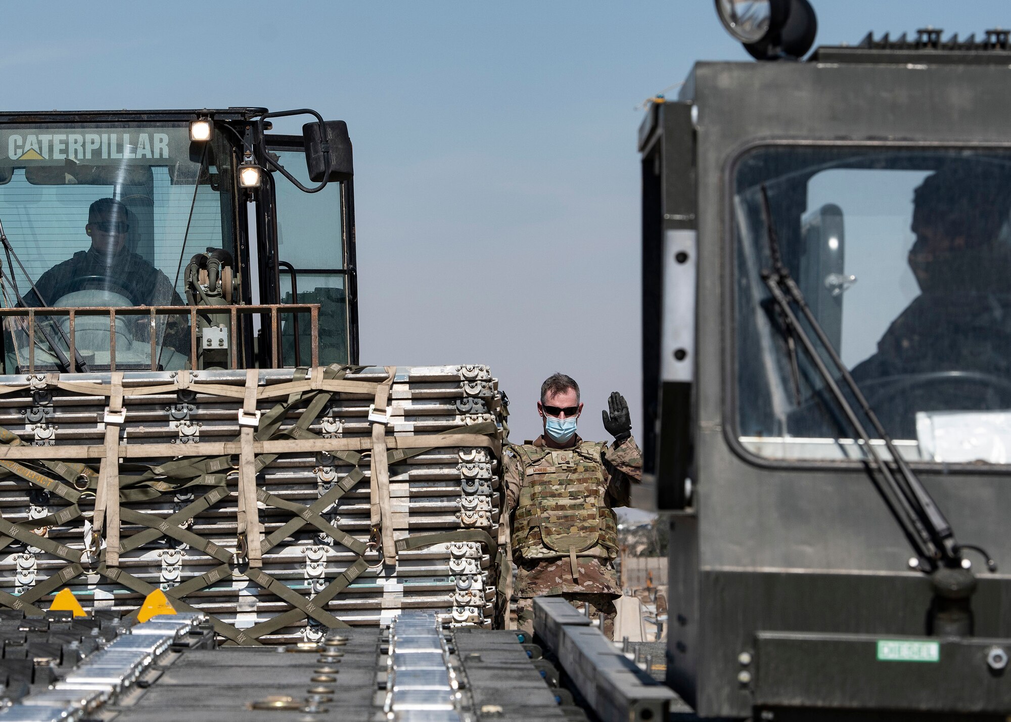 A photo of an Airman directing machinery