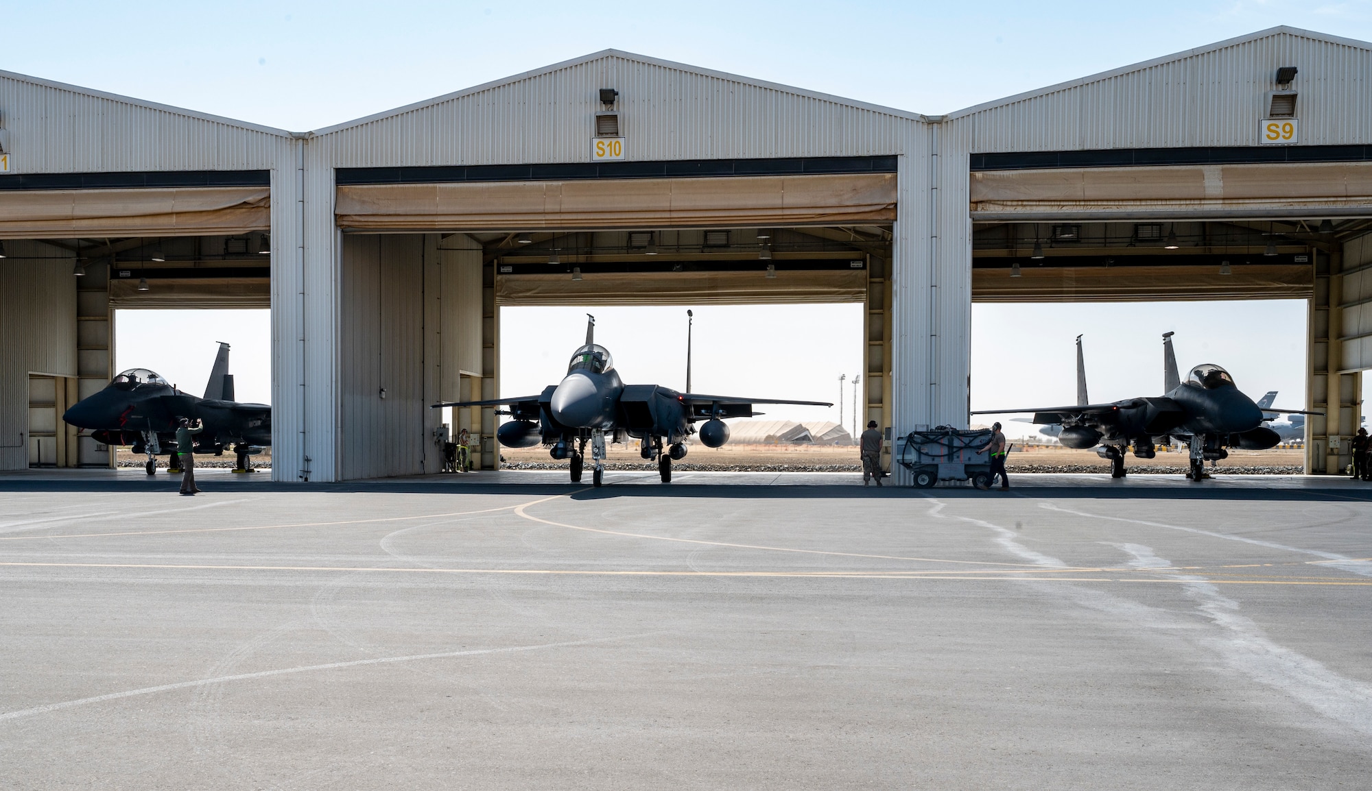 Three F-15E Strike Eagles assigned to the 335th Expeditionary Fighter Squadron prepare to taxi out during at Al Dhafra Air Base, United Arab Emirates, Feb. 18, 2021.