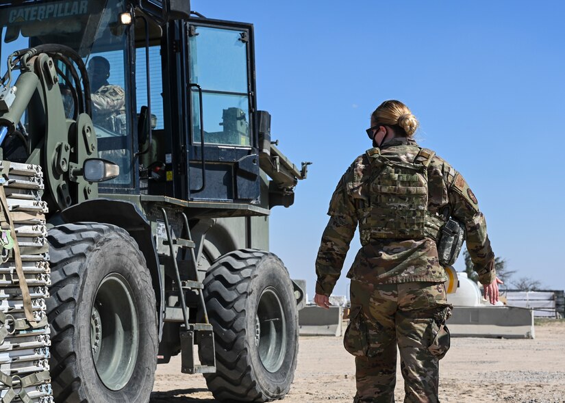 A photo of an Airman driving machinery