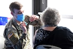 A Soldier with the Michigan Army National Guard administers a first dose of the COVID-19 vaccine during a mass vaccination clinic in Traverse City, Michigan, Feb. 23, 2021. The Michigan National Guard is helping local health care organizations vaccinate Michiganders.