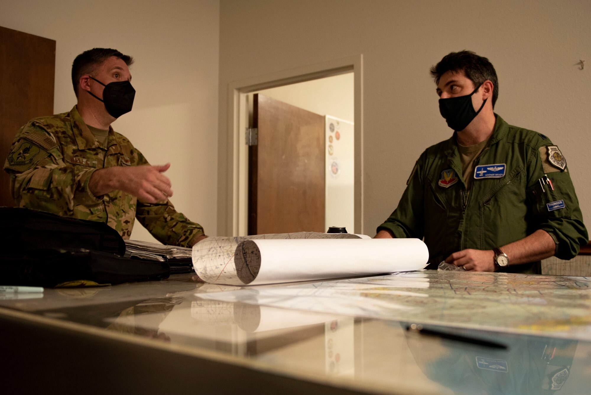 A photo of the 23d Wing commander going over plans with leadership.