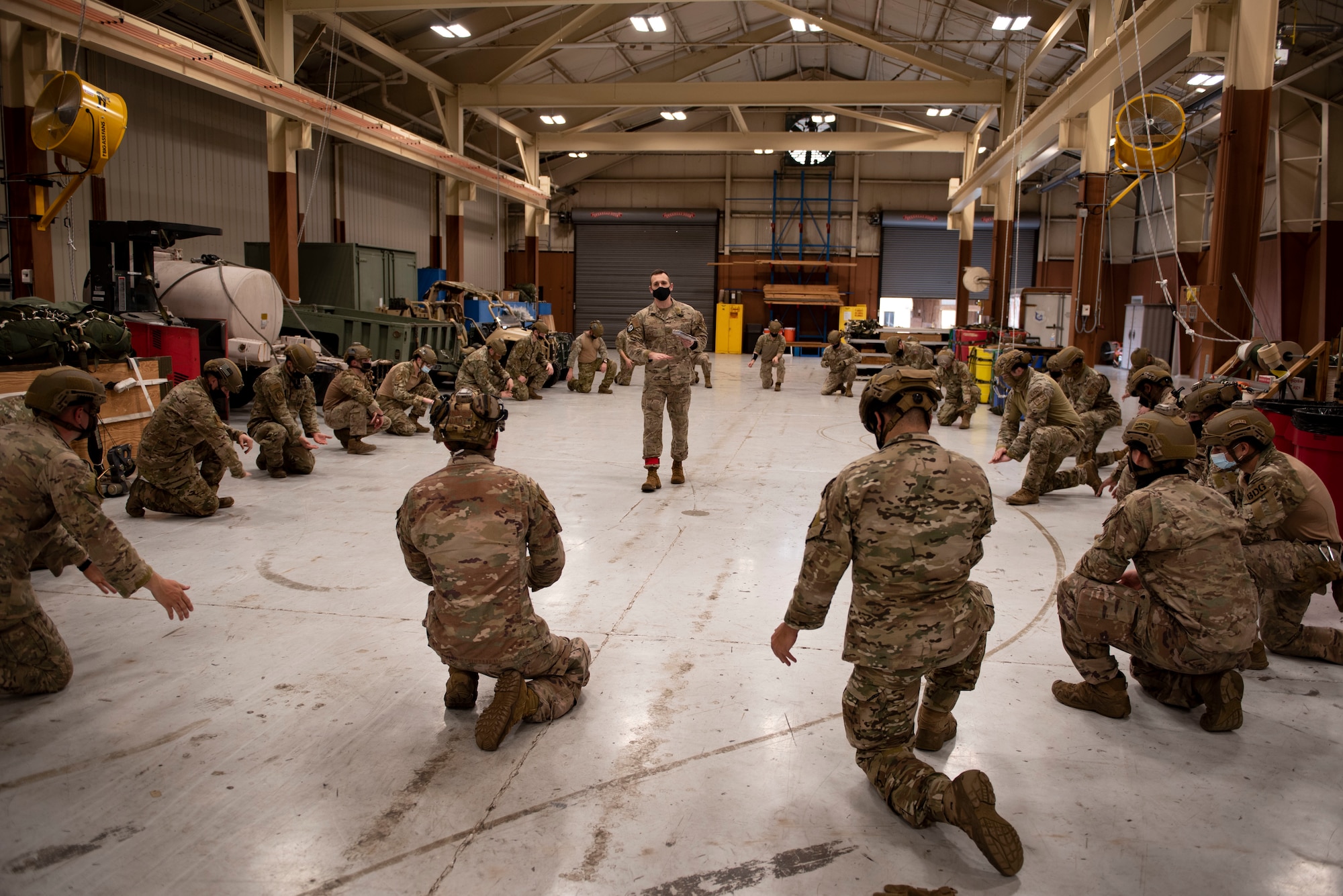 A photo of leadership explaining jumping procedures to Airmen.