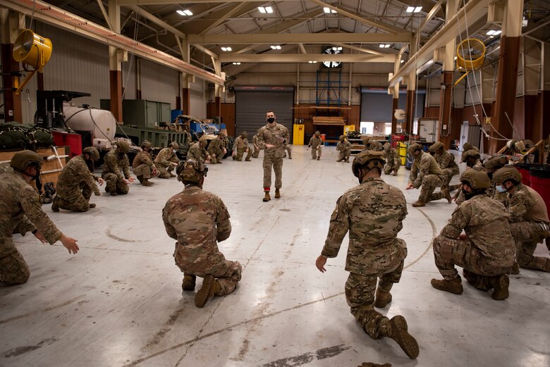 A photo of leadership explaining jumping procedures to Airmen.