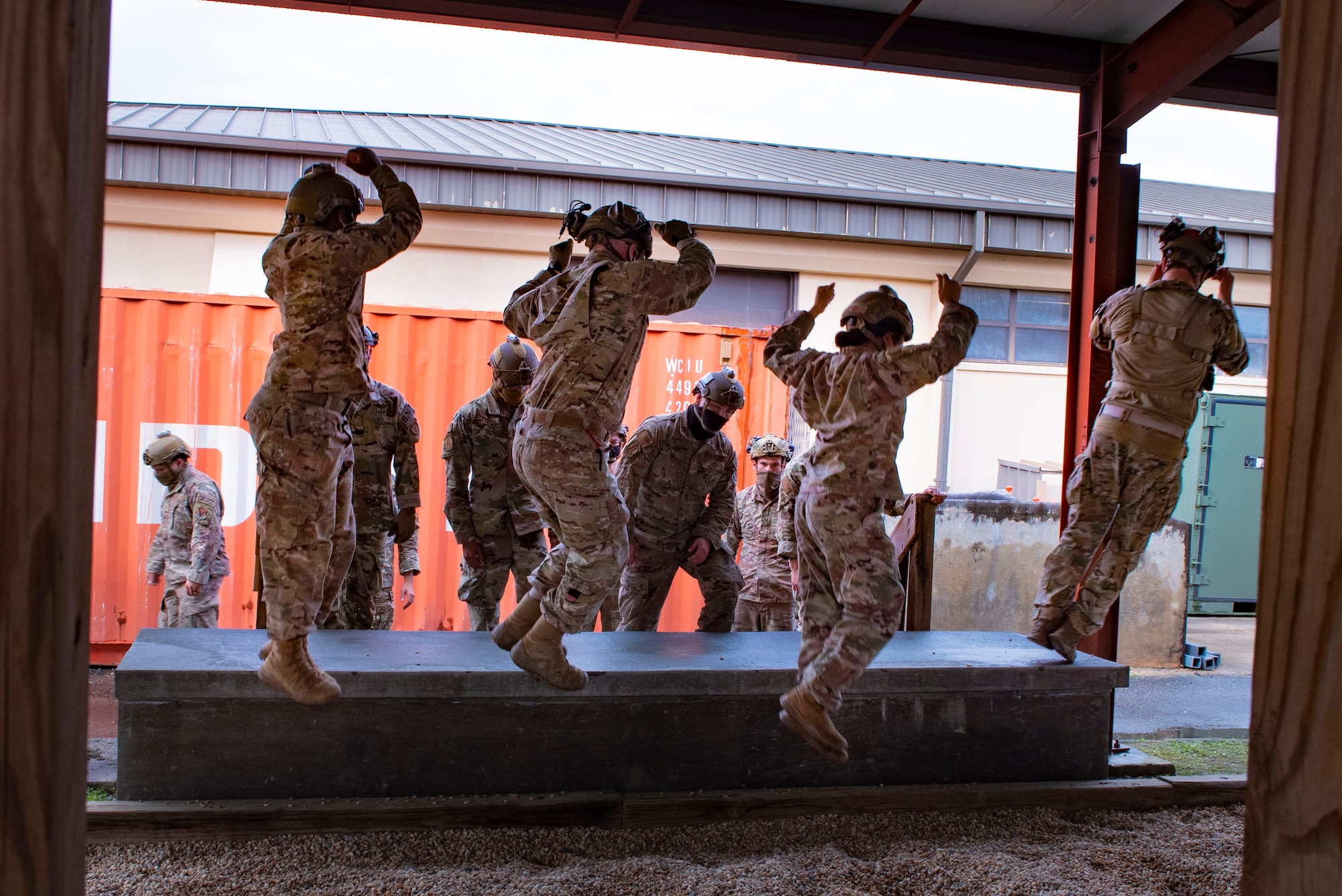 A photo of Airmen practicing landing before an airborne jump.