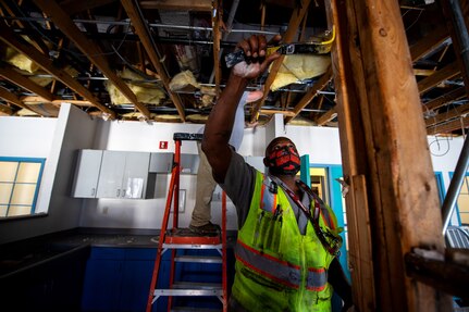 Samuel Burrell Sr., 502nd Civil Engineer Squadron maintenance mechanic, remove nails during the demolition phase of reconstruction Feb. 25, 2021, at Joint Base San Antonio-Lackland, Texas.