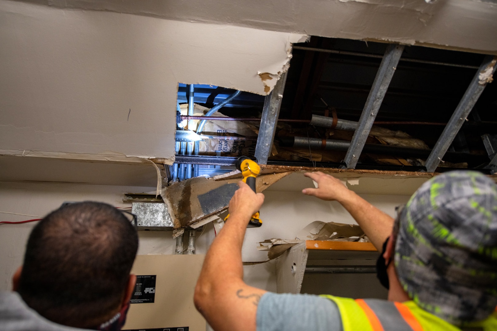 Michael Wergin, right, 502nd Civil Engineer Squadron utilities section, and a 502nd CES alarms system specialist, locate a leak in a waterline caused by recent severe winter storms, Feb. 24, 2021, at Joint Base San Antonio-Lackland, Texas.