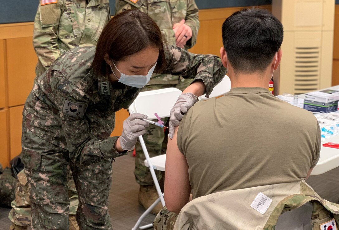 A South Korean Army nurse gives a soldier a shot in the arm.