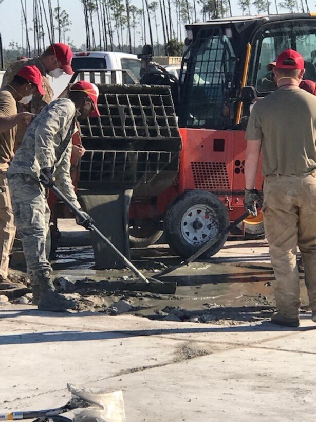 Airmen fill a test airfield crater