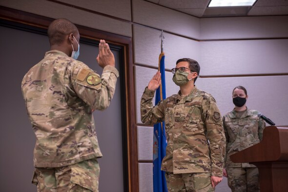 Maj. Kenneth Hawkins, 22nd Contracting Squadron commander, performs the Oath of Office for 2nd Lt Corey Cerritos, 22nd Contracting Squadron flight commander, to officially cross-commission him into the U.S. Space Force Feb. 12, 2021, at McConnell Air Force Base, Kansas. Cerritos is currently the only airman from Team McConnell to join the Space Force, paving the way for future Guardians. (U.S. Air Force photo by Staff Sgt. Nathan Eckert)