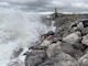 Waves batter the shoreline as crews work to repair the seawall at Cape Lisburne on Aug. 4, 2019.