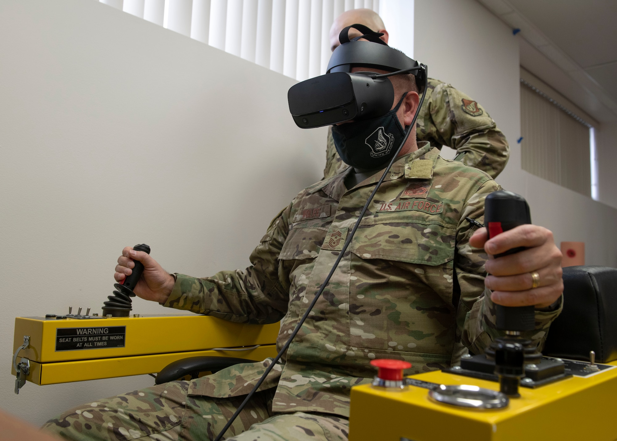 U.S. Air Force Chief Master Sgt. David Wolfe, the Pacific Air Forces command chief, uses the 3rd Maintenance Group’s de-icing simulator at Joint Base Elmendorf-Richardson, Alaska, Feb. 17, 2021. PACAF leadership conducted an immersion tour of JBER to learn about the installation's role in readiness and defense in the Arctic as well as how the base remains poised for the future through innovative ideas.