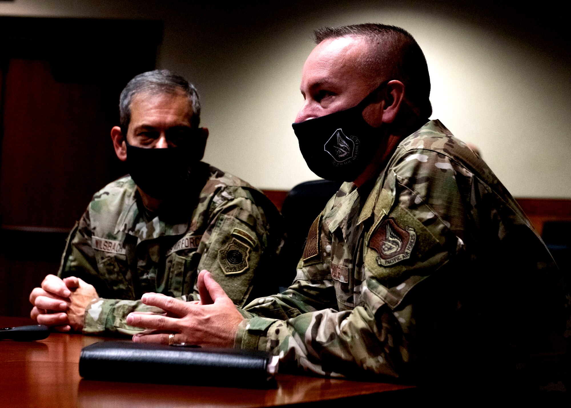 U.S. Air Force Chief Master Sgt. David Wolfe, the Pacific Air Forces command chief, right, and U.S. Air Force Gen. Kenneth Wilsbach, left, the Pacific Air Forces commander, talk to the 673d Air Base Wing and 3rd Wing during a virtual all-call at Joint Base Elmendorf-Richardson, Alaska, Feb. 18, 2021. PACAF leadership conducted an immersion tour of JBER to learn about the installation's role in readiness and defense in the Arctic as well as how the base remains poised for the future through innovative ideas.