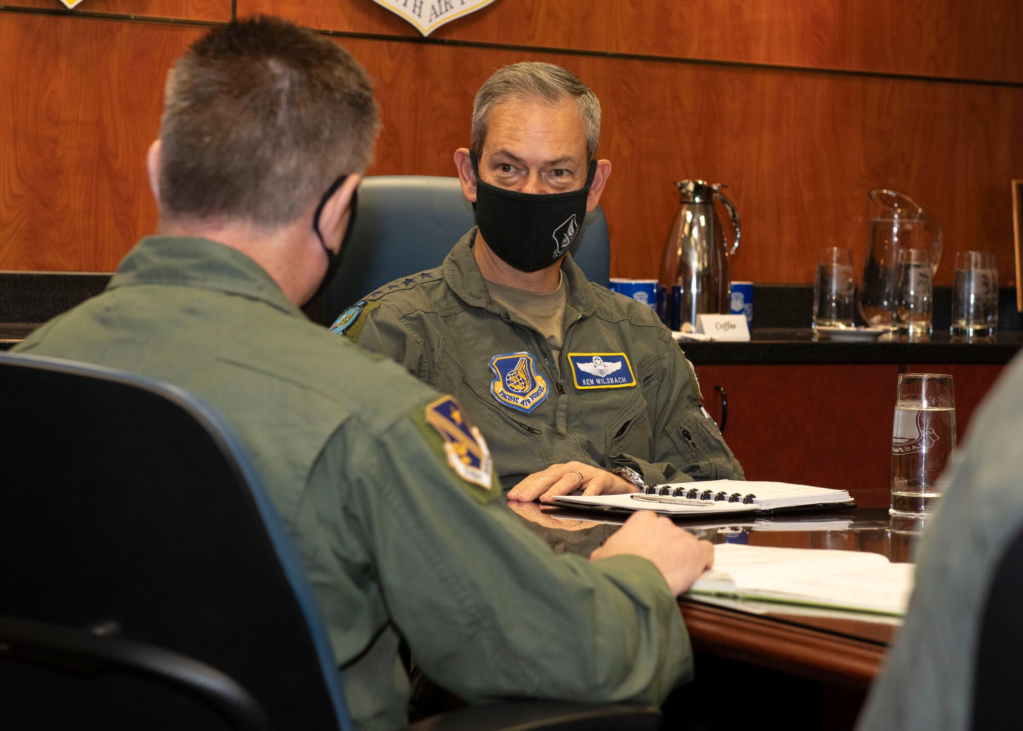 U.S. Air Force Gen. Kenneth Wilsbach, right, the Pacific Air Forces commander, talks to U.S. Air Force Brig. Gen. Anthony Stratton, left, the 176th Wing, Alaska Air National Guard commander, about the Alaska Air National Guard’s mission at Joint Base Elmendorf-Richardson, Alaska, Feb. 16, 2021. PACAF leadership conducted an immersion tour of JBER to learn about the installation's role in readiness and defense in the Arctic as well as focusing on how the base remains postured for the future through innovative ideas.