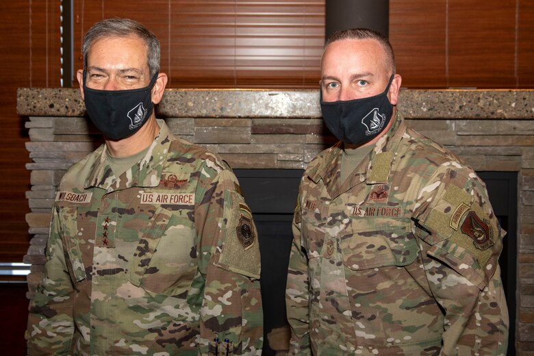 U.S. Air Force Gen. Ken Wilsbach, the Pacific Air Forces commander, and U.S. Air Force Chief Master Sgt. David Wolfe, the Pacific Air Forces command chief, display their Arctic tabs for a photograph at Joint Base Elmendorf-Richardson, Alaska, Feb. 18, 2021. PACAF leadership conducted an immersion tour of JBER to learn about the installation's role in readiness and defense in the Arctic as well as focusing on how the base remains postured for the future through new and innovative ideas.