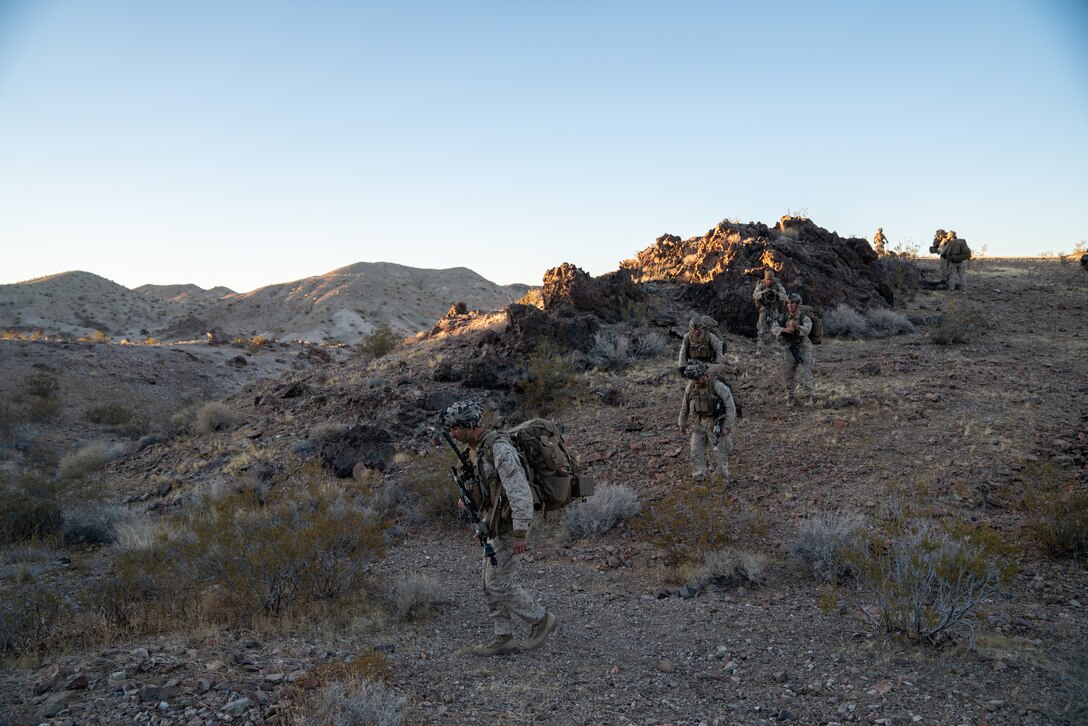 Marines with 2nd Battalion, 3rd Marines, patrol to a further checkpoint at the Marine Corps Air Ground Combat Center, Twentynine Palms, on February 17, 2021. Marines used Marine Warfighting Exercise to strengthen their skills and tactics for fighting a near peer adversary. (U.S. Marine Corps photo by Lance Cpl. Andrew R. Bray)