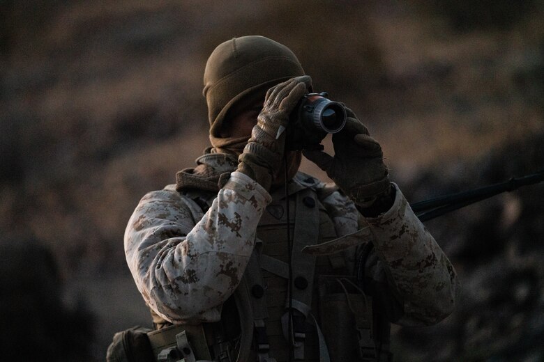 A Marines with 2nd Battalion, 3rd Marines, checks and adjusts a thermal optic at the Marine Corps Air Ground Combat Center, Twentynine Palms, on February 17, 2021. Marines used Marine Warfighting Exercise to strengthen their skills and tactics for fighting a near peer adversary. (U.S. Marine Corps photo by Lance Cpl. Andrew R. Bray)