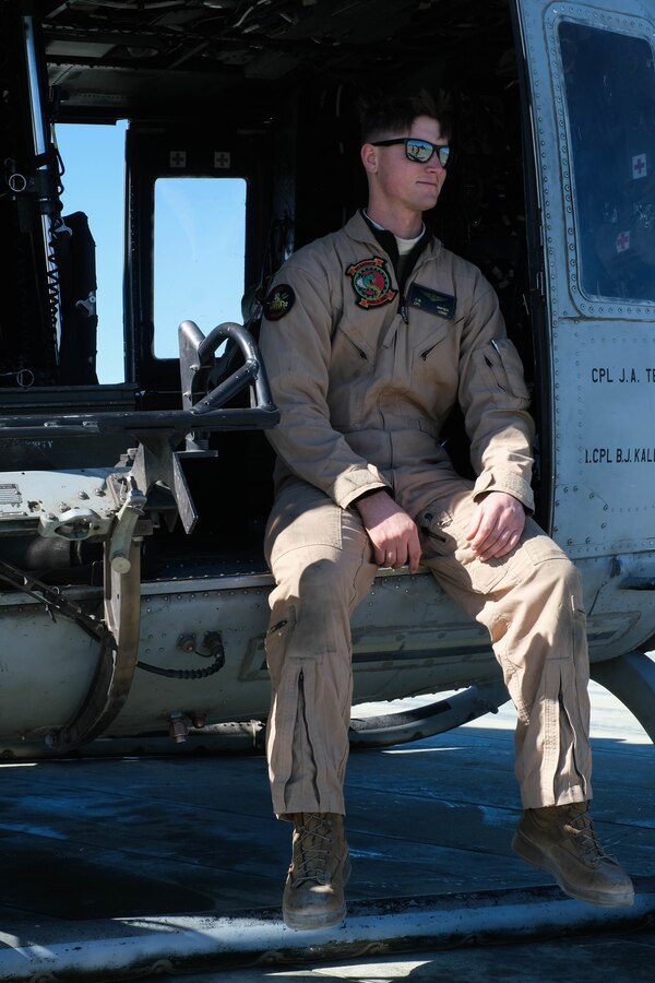 U.S. Marine Corps Cpl. Carter Mayer, flightliner, Marine Light Attack Helicopter Squadron, Marine Aircraft Group 24, 1st Marine Aircraft Wing, poses for a portrait in a Bell UH-1Y Venom utility helicopter during MAGTF Warfighting Exercise 2-21 on Marine Corps Air Ground Combat Center, Twentynine Palms, California, February 18, 2021. MWX is a force on force exercise designed to challenge the MAGTF, other U.S. forces, and allied nations' militaries against a peer adversary in a free play environment in order to assist forces with meeting current and future real world operational demands. (U.S. Marine Corps photo by Lance Cpl. Therese Edwards)