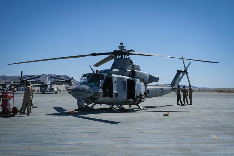 A U.S. Marine Corps Bell UH-1Y Venom utility helicopter awaits utilization during MAGTF Warfighting Exercise 2-21 on Marine Corps Air Ground Combat Center, Twentynine Palms, California, February 18, 2021. MWX is a force on force exercise designed to challenge the MAGTF, other U.S. forces, and allied nations' militaries against a peer adversary in a free play environment in order to assist forces with meeting current and future real world operational demands. (U.S. Marine Corps photo by Lance Cpl. Therese Edwards)