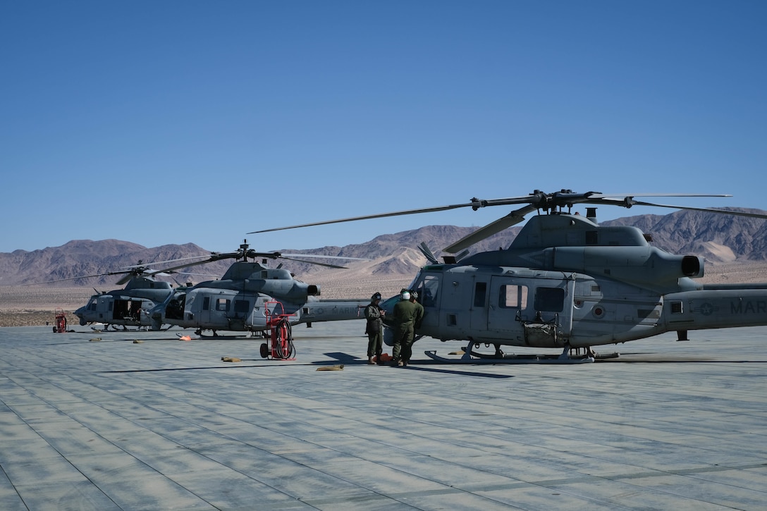 A U.S. Marine Corps Bell UH-1Y Venom utility helicopter awaits utilization during MAGTF Warfighting Exercise 2-21 on Marine Corps Air Ground Combat Center, Twentynine Palms, California, February 18, 2021. MWX is a force on force exercise designed to challenge the MAGTF, other U.S. forces, and allied nations' militaries against a peer adversary in a free play environment in order to assist forces with meeting current and future real world operational demands. (U.S. Marine Corps photo by Lance Cpl. Therese Edwards)