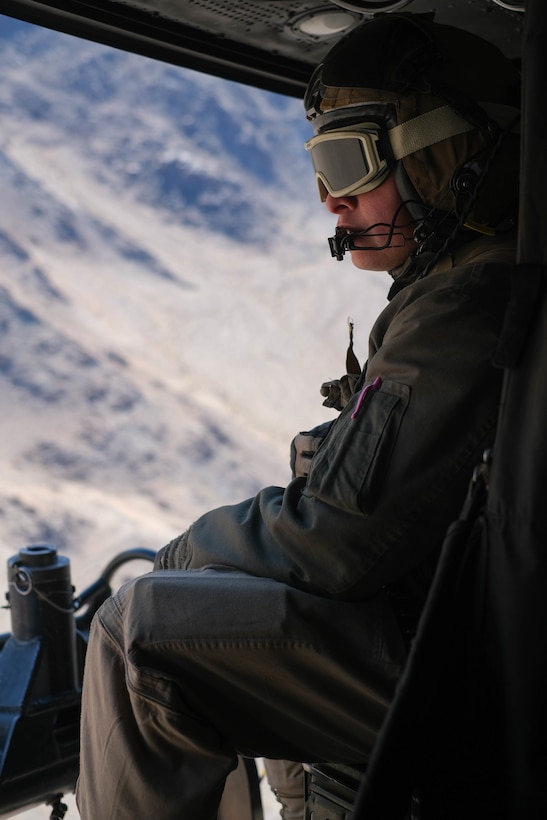 U.S. Marine Corps Cpl. Francisco Diazavendano, helicopter crew chief, Marine Light Attack Helicopter Squadron 367, Marine Aircraft Group 24, 1st Marine Aircraft Wing, rides in a Bell UH-1Y Venom utility helicopter during MAGTF Warfighting Exercise 2-21 on Marine Corps Air Ground Combat Center, Twentynine Palms, California, February 18, 2021. MWX is a force on force exercise designed to challenge the MAGTF, other U.S. forces, and allied nations' militaries against a peer adversary in a free play environment in order to assist forces with meeting current and future real world operational demands. (U.S. Marine Corps photo by Lance Cpl. Therese Edwards)