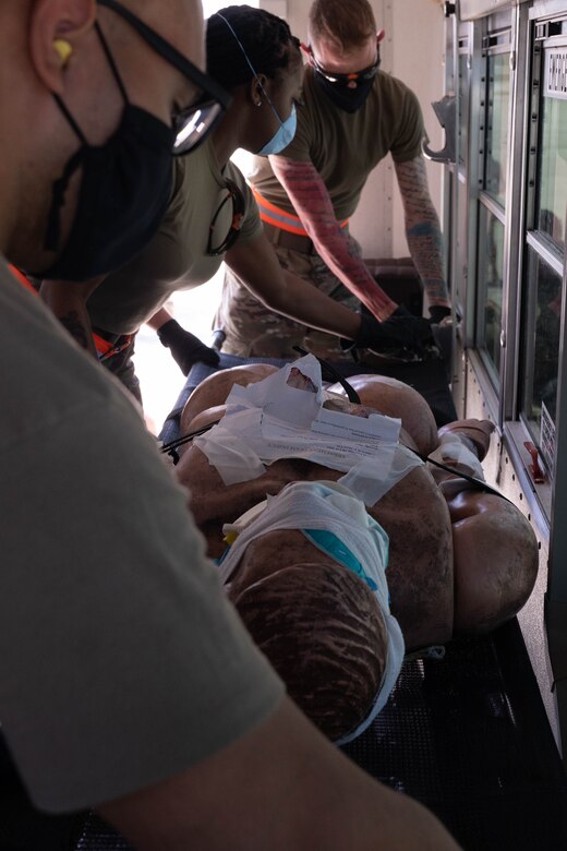 U.S. Air Force Airmen with the 36th Medical Group prepare to secure a litter before transporting a patient during a mass casualty exercise at Andersen Air Force Base, Guam, Feb. 10, 2021.