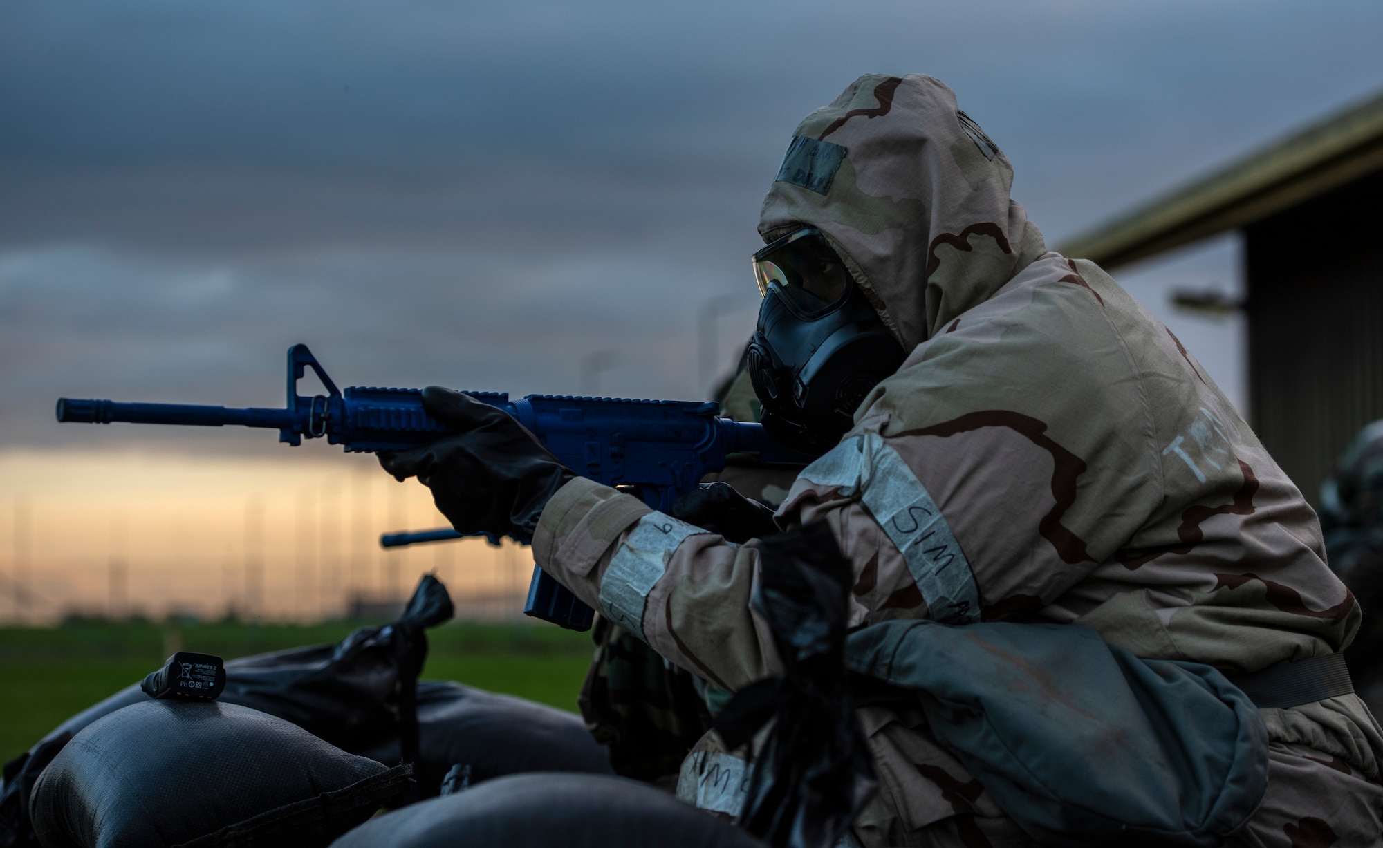 U.S. Air Force Senior Airman Kalif Daly, 48th Civil Engineering Squadron water and fuel systems maintenance journeyman, assumes a defensive fighting position during a readiness training at Royal Air Force Feltwell, Nov. 4, 2020. The monthly training serves to enhance and maintain response to real-world scenarios through teamwork and practical application. (U.S. Air Force photo by Airman 1st Class Jessi Monte)