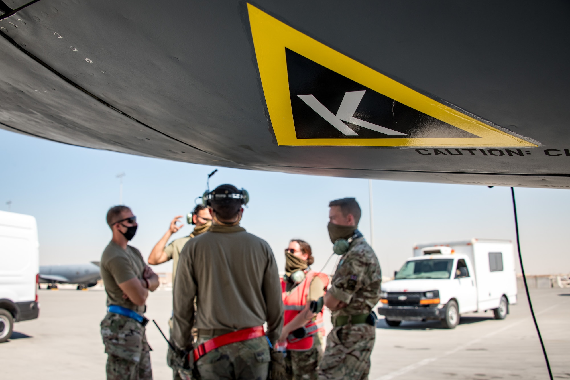triangle k patch on airplane with airmen in background