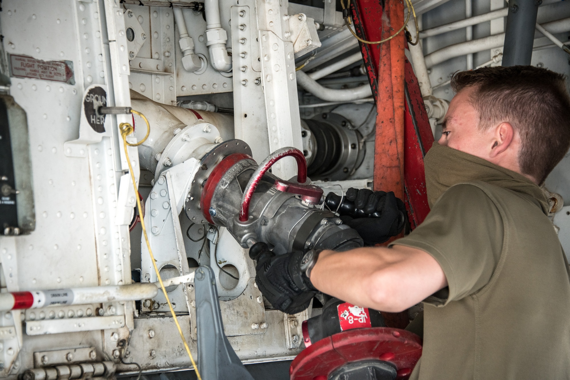 Royal Air Force member attaches fuel hose to aircraft