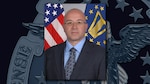A portrait of Mike Scott on a DLA emblem background