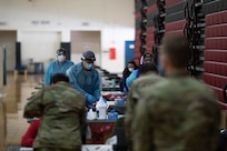 U.S. Army Soldiers assigned to the 627th Hospital Center out of Fort Carson, Colo., register for rapid COVID testing at a state-run, federally-supported Community Vaccination Center in Elizabeth, N.J., Feb. 21, 2021.