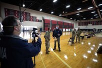 U.S. Air Force Brig. Gen. Wayne McCaughey, New Jersey dual status commander and Director of the Joint Staff for the New Jersey National Guard, speaks with the Federal Emergency Management Agency Reception, Staging, Onward Movement, and Integration Specialist David Cucchi at a state-run, federally-supported COVID Community Vaccination Center in Elizabeth, N.J. Director of the Joint Staff for the New Jersey National Guard