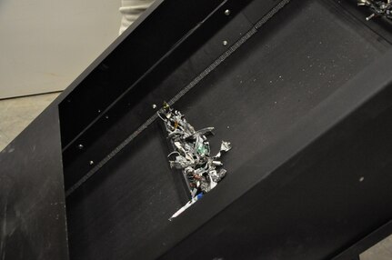 IMAGE: The mangled strip of metal is all that remains of hardware containing sensitive material following its trip through the GigaBiter.