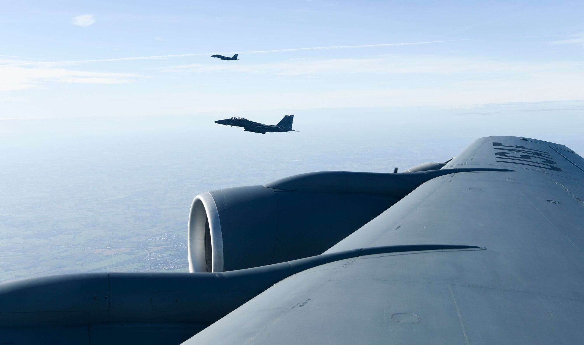 U.S. Air Force F-15E Strike Eagle aircraft assigned to the 48th Fighter Wing, Royal Air Force Lakenheath, England, fly in formation with a KC-135 Stratotanker aircraft assigned to the 100th Air Refueling Wing from RAF Mildenhall, England, Feb. 24, 2021. The flight was in support of Estonian Independence Day, promoting defense cooperation, key to the U.S-Estonia relationship. (U.S. Air Force Photo by Airman 1st Class David C Busby)