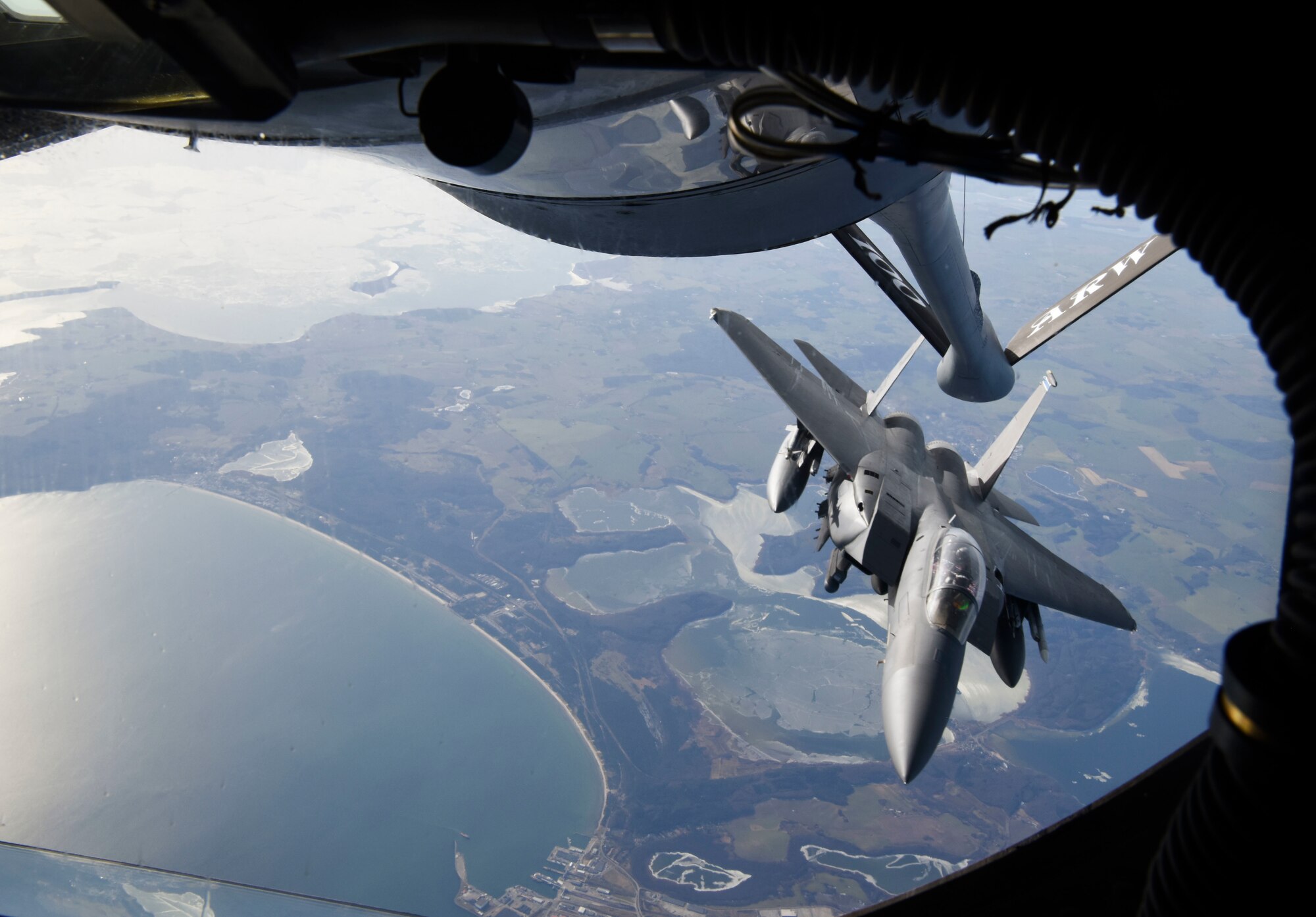 One of four U.S. Air Force F-15E Strike Eagle aircraft assigned to the 48th Fighter Wing, Royal Air Force Lakenheath, England, finishes refueling from a KC-135 Stratotanker aircraft assigned to the 100th Air Refueling Wing from RAF Mildenhall, England, as they fly to Estonia on their day of independence, Feb. 24, 2021. The four fighter jets participated in the Estonian Independence Day fly-over, joining L-39 training jets and a M-28 transport aircraft of the Estonian Air Force, Eurofighter Typhoon fighter jets from the German Air Force deployed to Estonia as part of the Baltic Air Policing Mission, and Eurofighter Typhoon fighter jets from the Italian Air Force deployed as part of the Baltic Air Policing Mission in Lithuania. (U.S. Air Force Photo by Airman 1st Class David C Busby)