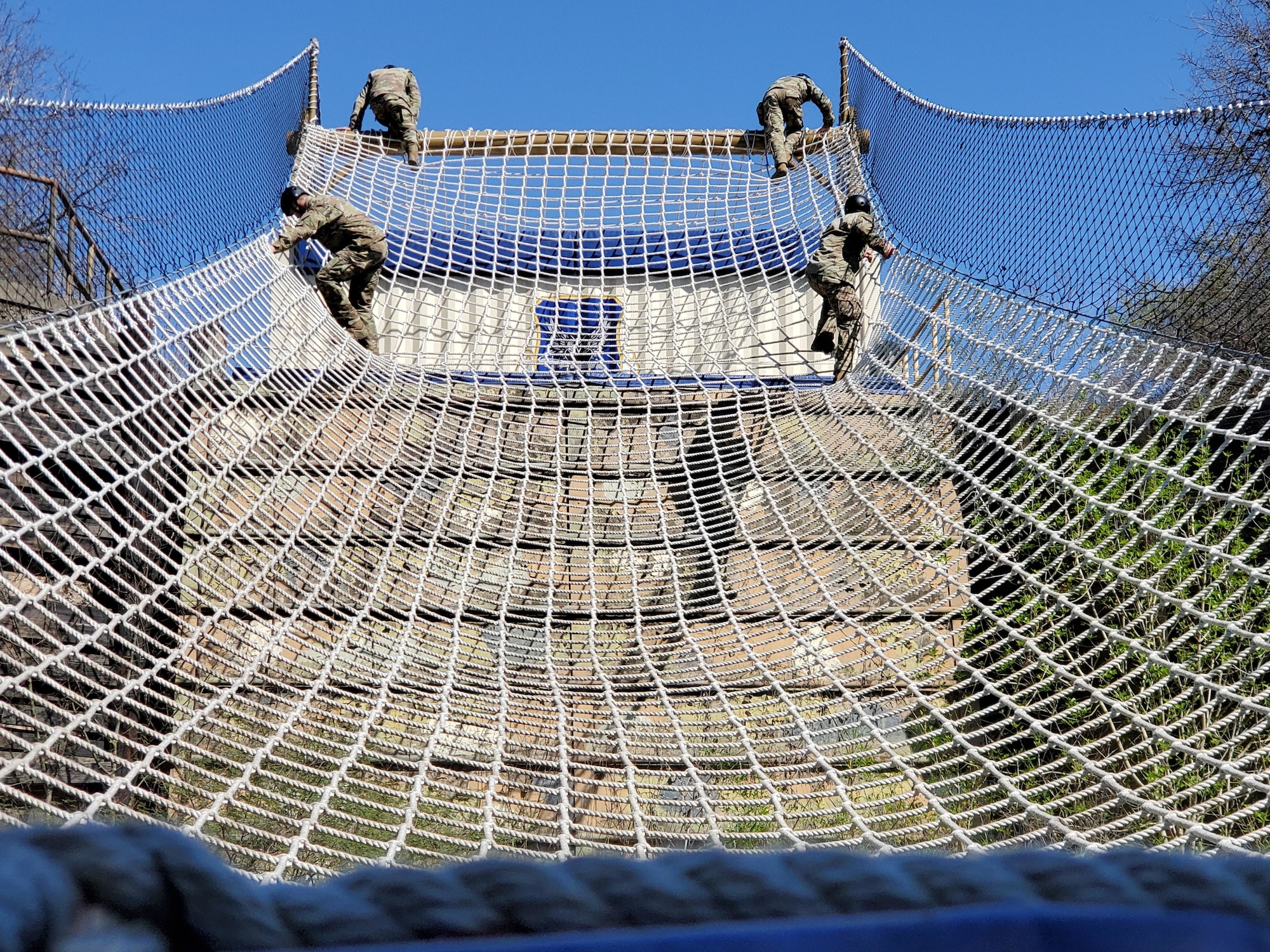 Special Warfare Airmen in training navigate an obstacle on the assualt course at Joint Base San Antonio-Lackland, Texas.