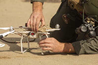 U.S. Marine Staff Sgt. Jeffrey B. Lysen, an explosive ordnance disposal Marine, takes apart a drone during a training event at Marine Corps Air Station Miramar, San Diego, California, Feb. 10, 2021. The EOD Marines with Headquarters and Headquarters Squadron train regularly to familiarize themselves with the proper disposal of explosives and maintain unit readiness. (U.S. Marine Corps photo by Lance Cpl. Jose S. GuerreroDeleon)