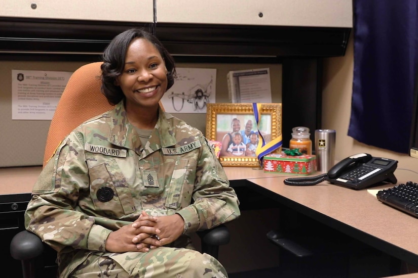 A soldier sits at a desk.